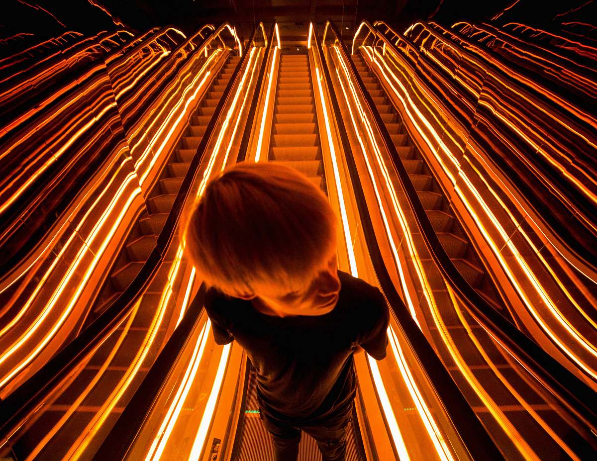 escalator man on escalator with light light